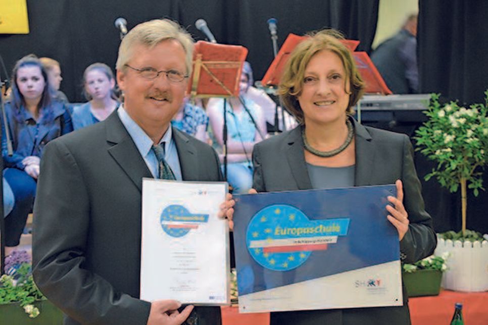 Bildungsministerin Britta Ernst und Schulleiter Thilo Philipp mit der Ernennungsurkunde zur Europaschule für die Schule an den Auewiesen.