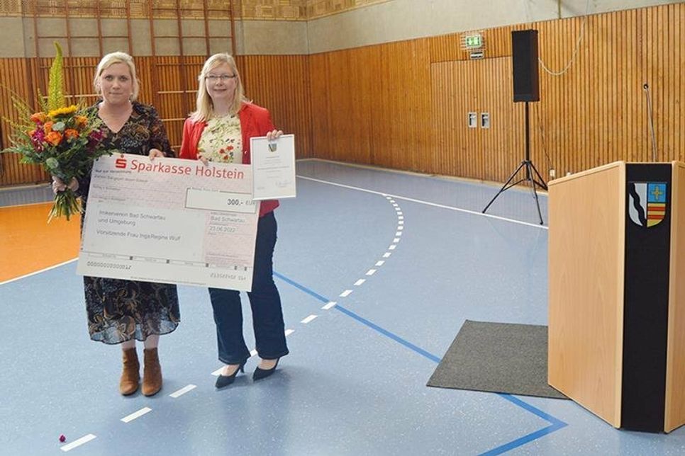 Bad Schwartaus Stadtpräsidentin Wiebke Zweig (li.) überreicht den diesjährigen Umweltpreis an Inga Wulf vom Imkerverein Bad Schwartau.
