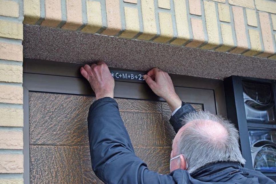 Der Segensspruch „Christus mansionem benedictat“ („Christus segne dieses Haus“) wird mit einem Aufkleber über der Haustür angebracht