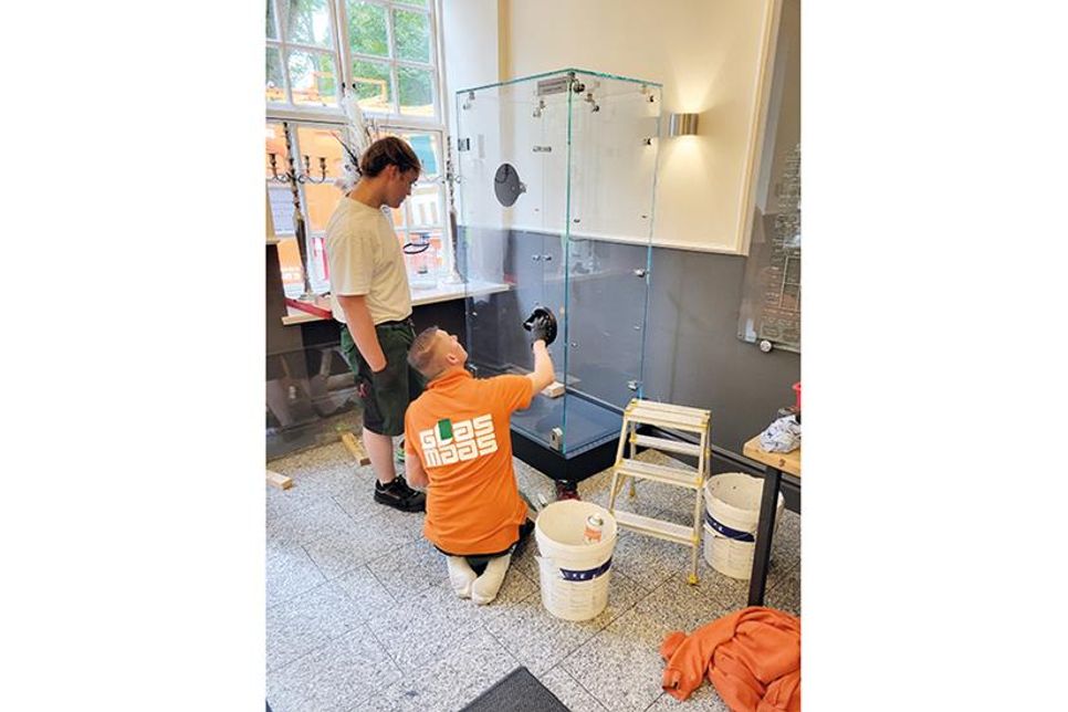Firmenchef Julian Maas (l.) und ein Mitarbeiter beim Aufbau der ersten Vitrine.
