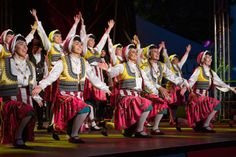 Tänzerinnen in traditionellen farbenfrohen Trachten begeistern das Publikum mit einer lebhaften folkloristischen Darbietung beim Folklorefest in Neustadt.