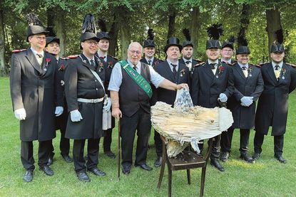 Oldenburgs neue Majestät Roland Lens mit Sohn Mirco im Rund der Leutnants und dem Rumpf des ehedem stolzen Gildevogels „Olaf C. ut de Meyerhoffstraat“.