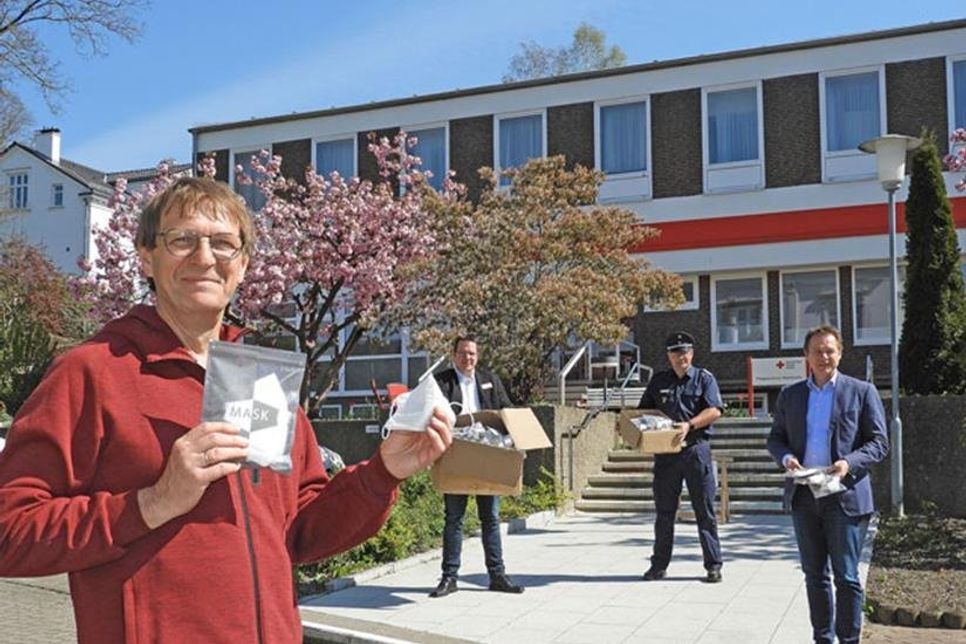 Michael Kasch (Stadt Eutin), Henning Meinecke (DRK Ostholstein), Gemeindewehrführer Marco Wriedt und Bürgermeister Carsten Behnk bei der Übergabe der Masken.