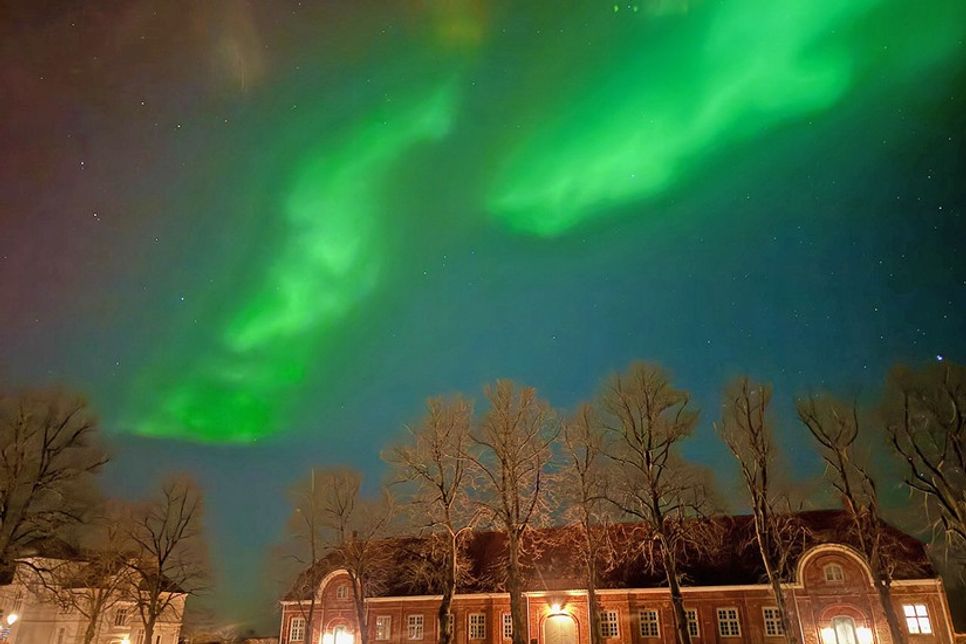 Über dem Marstall entwickelt sich am späten Abend des 19. Januars die lange Fahne eines mächtigen Polarlichts, das der historischen Kulisse des Plöner Schlossgebietes einen mystischen Anstrich verleiht