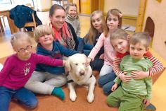 Kaum ist Hündin Feli im Kindergartengruppenraum angekommen, bildet sich eine Traube von Kindern um das Tier und alle wollen mit ihr kuscheln, knuddeln oder spielen. Foto: hfr