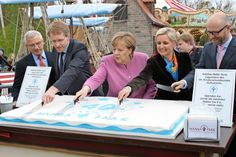 Tortenanschnitt: Andreas Leicht, Daniel Günther, Angela Merkel, Claudia Leicht und Peter Tauber setzten gekonnt das Messer an. Die Stücke wurden zugunsten des Deutschen Kinderschutzbundes Kreisverband Ostholstein verkauft.