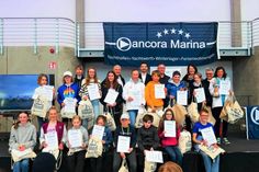 Die Plätze 1 bis 20 Opti A. Schnellstes Mädchen war Aileen Sorg vom NSV (2. Reihe re.), Oliver Seiter (ancora Marina), Jan Schwarzer (Arborea Marina Resort Neustadt), Philip Ismar (NSV, Wettfahrtleiter), Antje Weise (NSV, Jury), Rika Bredehorst (NSV, Regattateam) (3. Reihe von lks.).