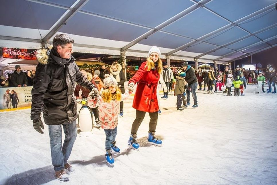 Direkt an der Hafenkante vergnügen sich Groß und Klein auf der Eisbahn.