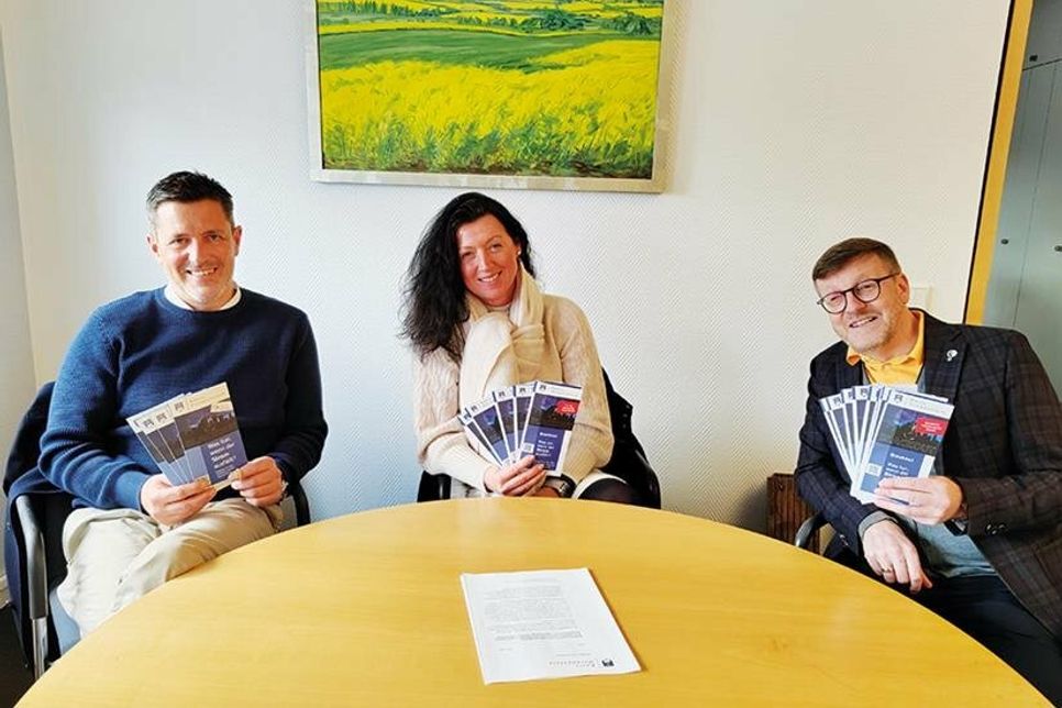 Die Bürgermeister der Gemeinden Ratekau, Scharbeutz und Timmendorfer Strand, Thomas Keller (links), Bettina Schäfer und Sven Partheil-Böhnke, mit dem jeweiligen Flyer ihrer Gemeinde.