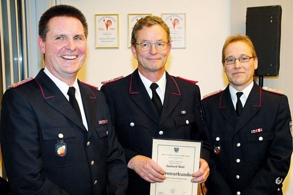 Ehrenurkunde für Gerhard Behl von Ortswehrführer Oliver Greve (rechts) und Roland Knoth.