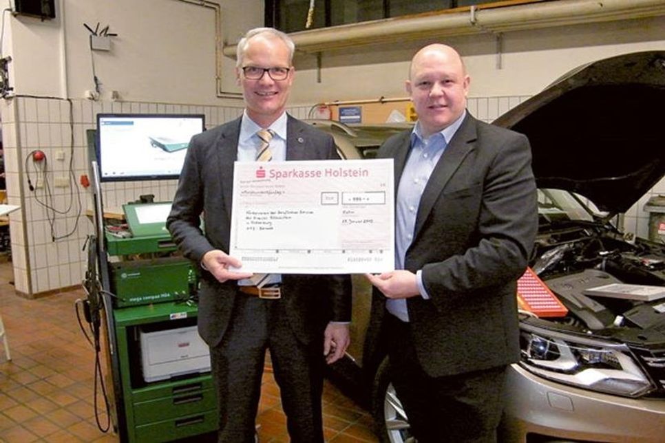 Obermeister Björn Bigga (r.) überreicht Michael Gülck einen symbolischen Scheck über 550 Euro für den Förderverein der Beruflichen Schule des Kreises Ostholstein in Oldenburg. Das Geld wurde gesammelt während der Freisprechungsfeier der Kfz-Innung Oldenburg Ende Januar im Schützenhof.