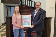 Bürgermeister Mirko Spieckermann und Nachhaltigkeitsmanagerin Lina Koop präsentieren die Urkunde.