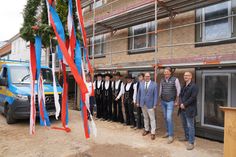 Die Zimmerleute der Firma Walter Hoffmann mit (v. re.) Leiter Hochbau (Stadt Neustadt) Patrick Zondler, Geschäftsführer der Zimmerei Hoffmann Ralf Hoffmann und Bürgermeister Mirko Spieckermann.