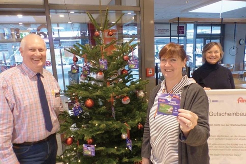 famila-Warenhausleiter Heinrich Evers, Familienhelferin Monika Schulze und die Vorsitzende des Kinderschutzbundes Heidi Feilke freuen sich über einen Wunschbaum, der das ganze Jahr über hilft: Bei famila dürfen wieder Gutscheine gepflückt werden – sie kommen vom Kinderschutzbund Eutin betreuten Familien in Not immer dann zugute, wenn finanzielle Engpässe eintreten.