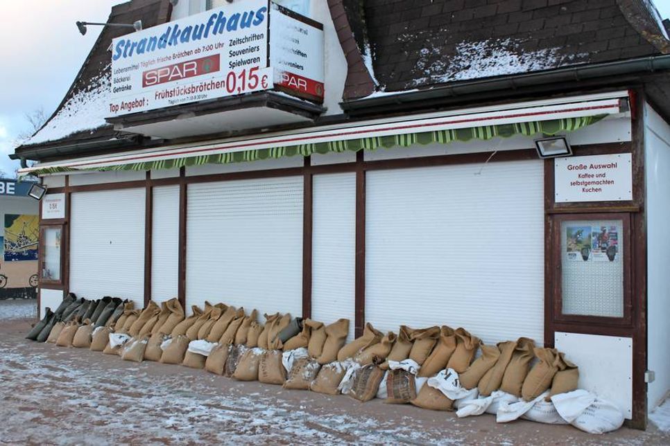 Sicherheit geht vor. Die Geschäfte an der Dahme Strandpromenade schützten sich mit Sandsäcken.