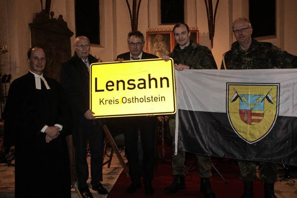 Ein Ortsschild der Gemeinde Lensahn geht mit nach Afghanistan. Übergabe mit Pastor Kai Sagawe, Bürgervorsteher Wolfgang Schüller, Bürgermeister Klaus Winter, Hauptmann Gerrit Sperling und Oberstabsfeldwebel Klaus Behring (v. lks.).