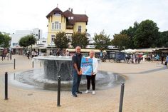 Dirk Scharbau (Feuerwehr Timmendorfer Strand) und Rotraut Schwarz (Strand Promotion) präsentieren das Plakat zum diesjährigen Feuerwehrfest. Foto: VA/hfr