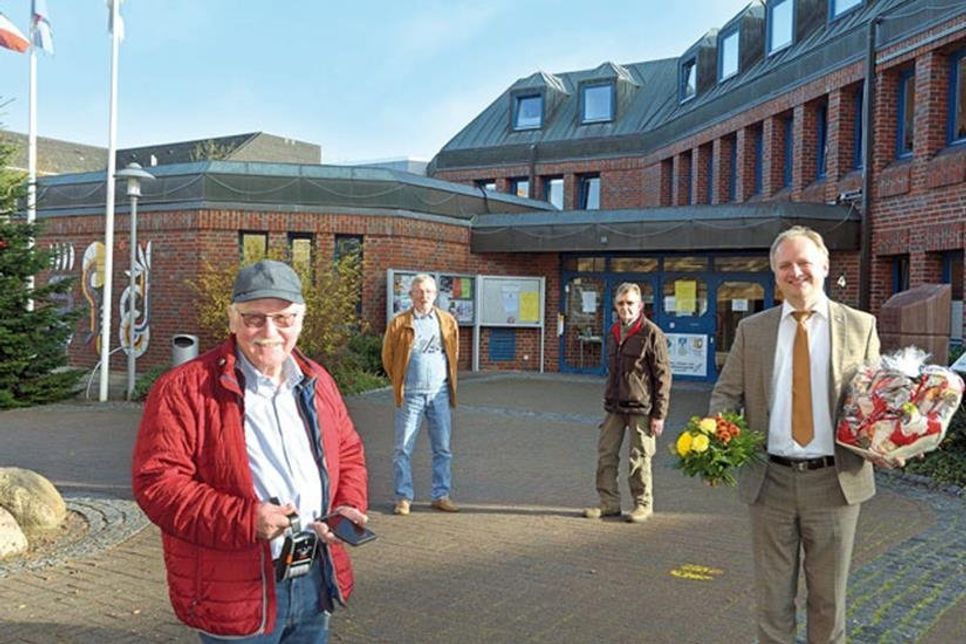 Blumen und Präsent am letzten Arbeitstag: Bürgermeister Peter A. Kokocinski hat Schönberger langjährigen Verkehrsüberwacher Jürgen Ehlers (l.) verabschiedet. Als Nachfolger wird Uwe Toschke (2. v. r.) künftig mit seinem Ehlers Kollegen Eckhard Penner die Parkräume der Gemeinde überwachen.