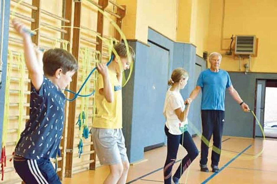 Marik Wenndorf, Mattis Weber und Greta Marlen Jesse ließen sich im Rahmen des Projekts Skipping Hearts von Übungsleiter Martin Curth buchstäblich „auf die Sprünge“ helfen.