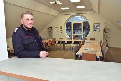 Im Obergeschoss befindet sich der Versammlungsraum der Feuerwehr. Der stellvertetende Wehrführer Hendrik Wenske lehnt an der Durchreiche zur großzügigen Küche.