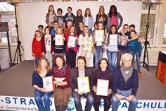 Nicht nur die Schüler der Klasse 6a der GGS-Strand sind stolz auf ihr Bilderwörterbuch, sondern auch Weltkunde-Lehrerin Bettina Kammholz (vorne von links), Klassenlehrerin Gabriele Lamprecht, Schulleiter Hans-Georg Rath, Bürgermeisterin Hatice Kara und Inititator Joachim Nickel.