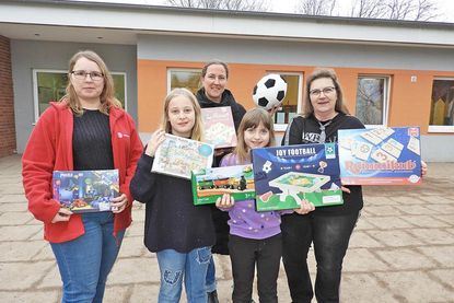 Irina Lüth (Leiterin „Zauberhut“, li.) freut sich mit Helene und Maria über das Spielzeug, das Silke Mildner (re.) und Susanne Handt vom reporter übergaben.