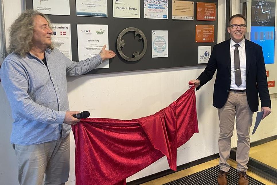BBZ-Schulleiter Torge Indinger (rechts) und Religionslehrer Robert Zeidler enthüllten gemeinsam die neue Stahl-Plastik „Engel der Kulturen“ in Preetz