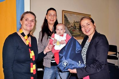 Bürgervorsteherin Anja Evers (li.) und Bürgermeisterin Hatice Kara überreichen das erste Begrüßungspaket für Neugeborene an Milena (fünf Monate) und ihre Mutter Stefanie. (Foto: René Kleinschmidt)