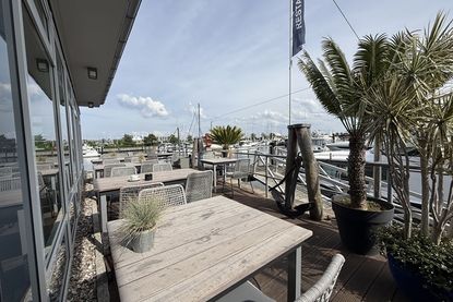 Die Terrassentische entstanden aus Holz alter Stege der Marina und erzählen ein Stück Hafengeschichte.