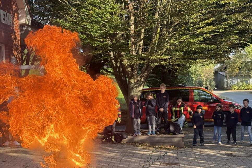 In sicherem Abstand verfolgten die Kinder, wie der Fettbrandsimulator eine gewaltige Flamme in die Höhe schießen lässt.