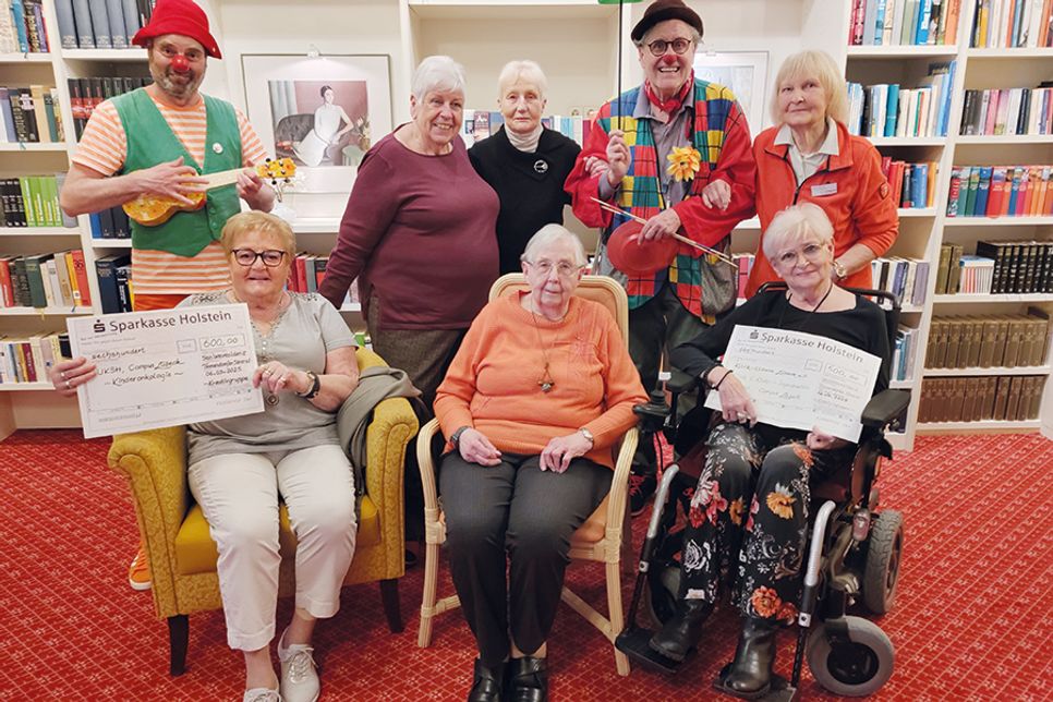 Scheckübergabe in der Seniorenresidenz mit Erika Weigandt (hi. re.), Holger Stüve (hi.li.) und Gerhard Flassak von „Klinik-Clowns-Lübeck e.V.“ (hi. 2.v.re.) sowie einigen Mitgliedern der Kreativgruppe, Margrit Krinke (vorne von links), Ingeborg Springer und Bärbel Steenbock und Anne Barbara Frühling (hi.2.v.li.) und Ute Rahmann. Auf dem Foto fehlt Dr. Martin Demmert vom UKSH.