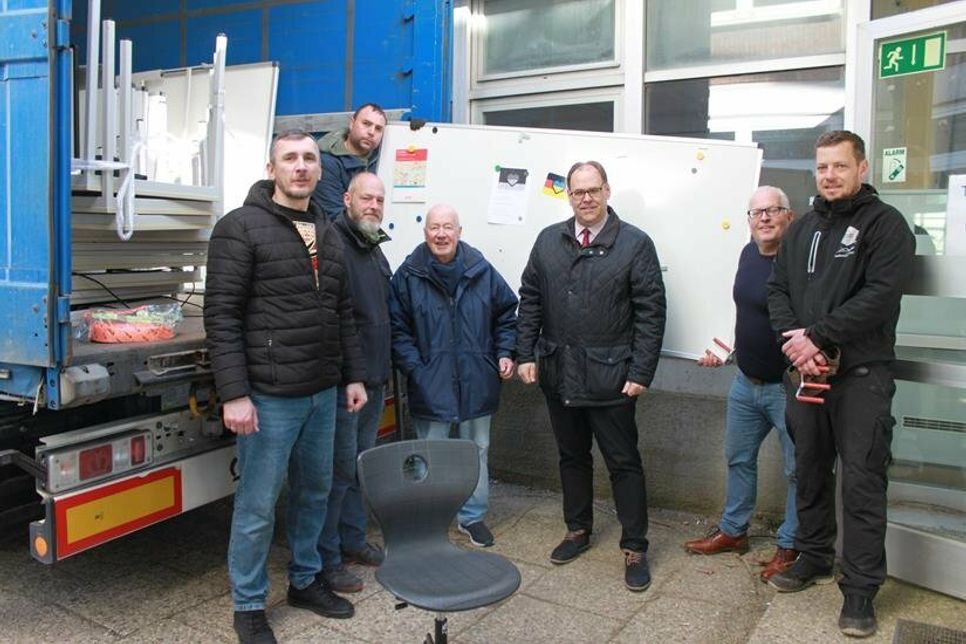 Oleg Beresnev, Hausmeister André Fink, Bürgervorsteher Sönke Sela, Bürgermeister Mirko Spieckermann, Heiko Haase und Bartel Witt (unten v. lks.) beim Verladen der Möbel.