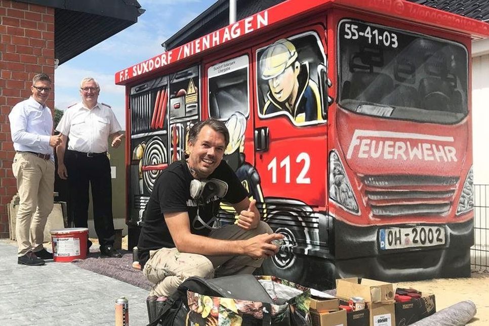 „Gute Ideen, Vorschläge und Hinweise sind im Ortsbeirat stets sehr willkommen“, sagt der Vorsitzende Olaf Dose-Miekley und freut sich mit Wehrführer Thorsten Ahrens über die prompte Umsetzung der Neugestaltung. (Graffiti Copyright 2019 Wandgestalten)