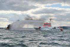 Der Seenotrettungskreuzer FELIX SAND der DGzRS bekämpft den Brand auf einer Segelyacht vor Travemünde.