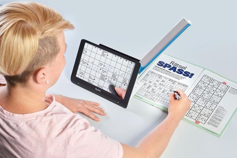 Eine praktische Neuentwicklung im Bereich elektronischer Lupen ist der ausklappbare Kameraarm, der gleichzeitiges Lesen und Schreiben ermöglicht. (Foto: djd/A. Schweizer)