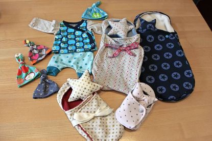 Mützchen, Taschen und Deckchen in unterschiedlichen Größen und bunten Farben - eine Ehrung für ein ungelebtes Leben.