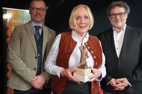 Gratulation: Die geehrte Beate Ruge mit Bürgermeister Stefan Schwardt (lks.) und Tourismusleiter Raymond Kiesbye.