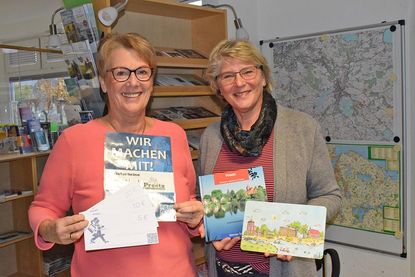Carmen Schwarz (links) und Ruth Fischer bieten in der Tourist-Information neben Einkaufsgutscheinen (StadtGutschein) auch echte Preetzer Originale an, z. B. in Buchform, oder ganz Praktisches, als Frühstücksbrettchen