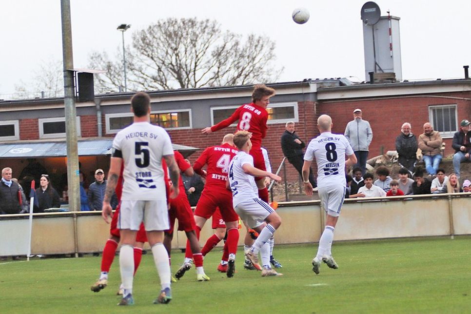 Paul Kuszak (Nummer 8) köpft den Ball wuchtig aus der Gefahrenzone.