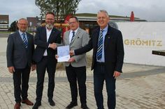 Bürgervorsteher Matthias Dammer, Wirtschafts- und Tourismusminister Claus Ruhe Madsen, Bürgermeister Sebastian Rieke und Tourismusleiter Manfred Wohnrade (v. lks.) bei der Übergabe im Dünenpark.