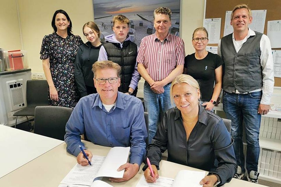 Schulleiterin Esther Passig und  Tourismuschef Joachim Nitz unterzeichnen die Kooperationsvereinbarung vor den Augen von Silke Szymoniak (TSNT GmbH, hi. v.li.), den Schülersprechern Emelia Rizzuti und Til Gosch, Stefan Kloth (HWK/IHK), Verbindungslehrerin Sabine Jensen und Björn Becker-Sowoidnich, Beauftragter für berufliche Bildung.