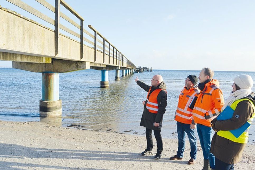 Andreas Geist (v.l.), verdeutlicht mit Bauleiter Torsten Hauser, Torsten Langkämper vom Planungsbüro sowie Biologin Maren Rohrbeck wie die Seebrücke in Scharbeutz abgebaut werden soll.