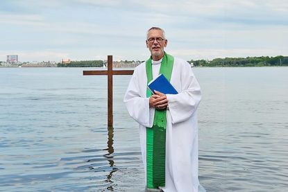 Pastor Joachim Thieme-Hachmann bei einer Taufe am Fördestrand.