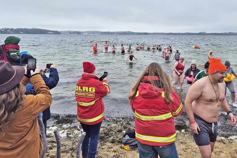 Typisches Badewetter sieht anders aus. Das hielt aber am ersten Sonnabend im neuen Jahr 33 Mutige nicht davon ab, sich beim vom DLRG Hutzfeld-Bosau veranstalteten Anbaden in die eisigen Fluten des Großen Plöner Sees zu stürzen. Etwa 100 Zuschauer hatten sich am Badestrand in Bosau versammelt und sahen zu, wie sich die wagemutigen, teils kostümierten Teilnehmer in den See begaben. Dieser war mit einem Grad plus zwar wärmer als die Luft mit minus einem Grad, aber das tat dem Kälteschock, der beim Eintauchen entstand, keinen Abbruch.