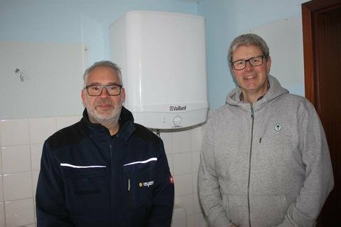 Frank Meier (lks.), Kundendienstleiter von H.F. Meyer Haustechnik, und Vaillant Außendienstmitarbeiter Michael Möller vor dem neuen Warmwasserspeicher.