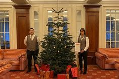 Die Empfangsmitarbeiter Gerald Kid Alonzo (links) und Angelina Otte neben dem Weihnachts-Wunschbaum im Atlantic Grand Hotel Travemünde.